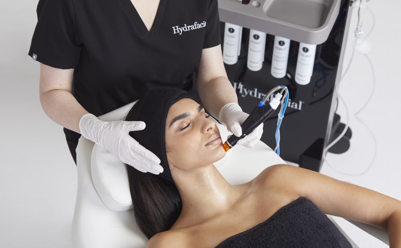 a woman receiving a hydrafacial treatment